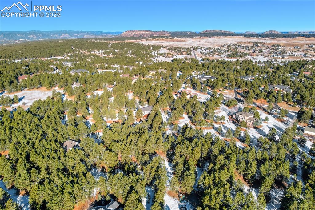 Aerial view of property's location featuring a mountain backdrop