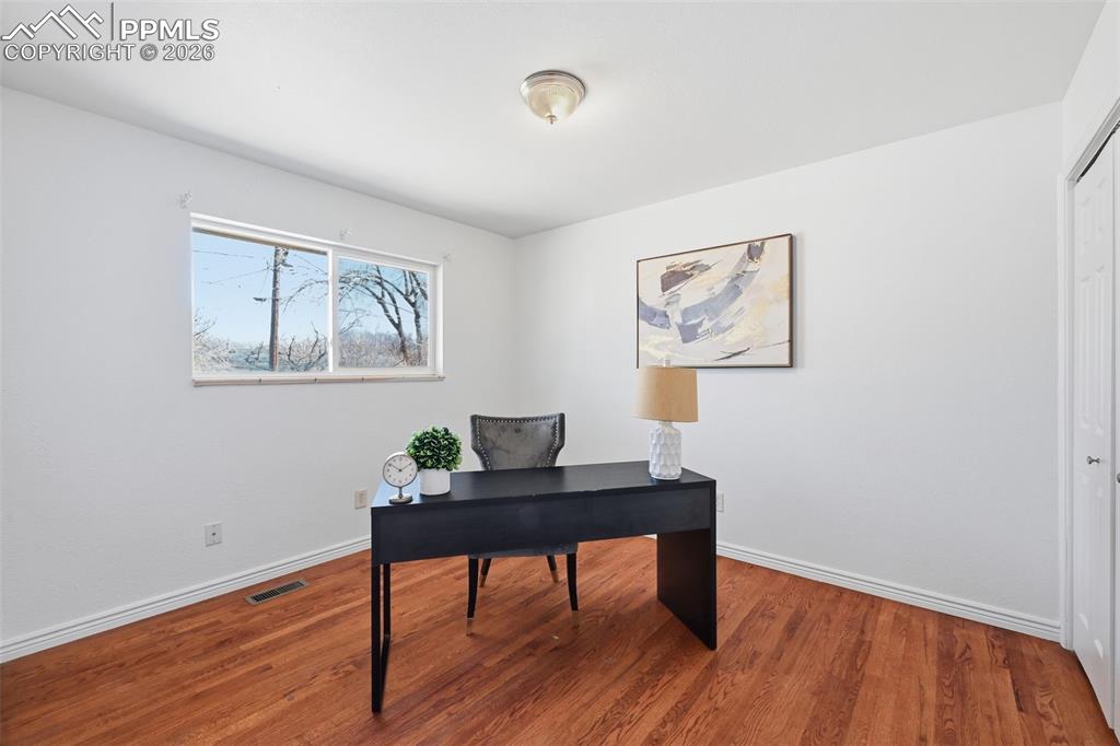 Large bright bedroom with real wood floors
