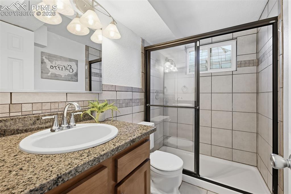 Bright basement bath with window and walk-in shower