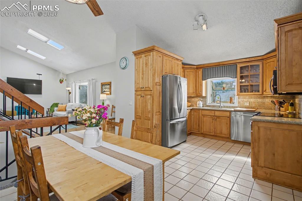 Kitchen with tile floors and stainless steel appliances