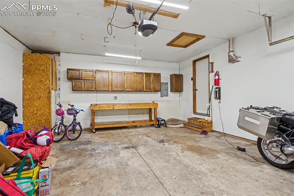 Garage with work bench and cabinetry