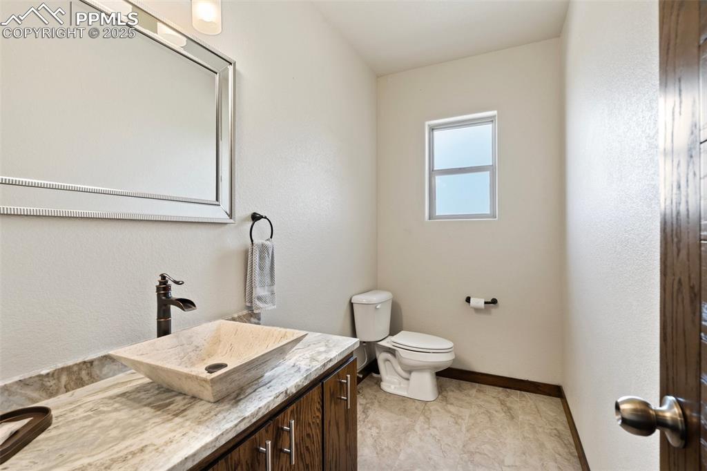 Main 1/2 Bathroom with vanity and toilet