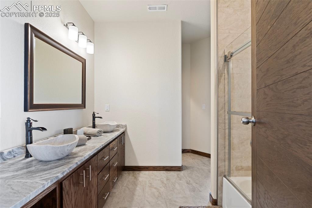 Jack and Jill Full bathroom with double vanity and  shower combination
