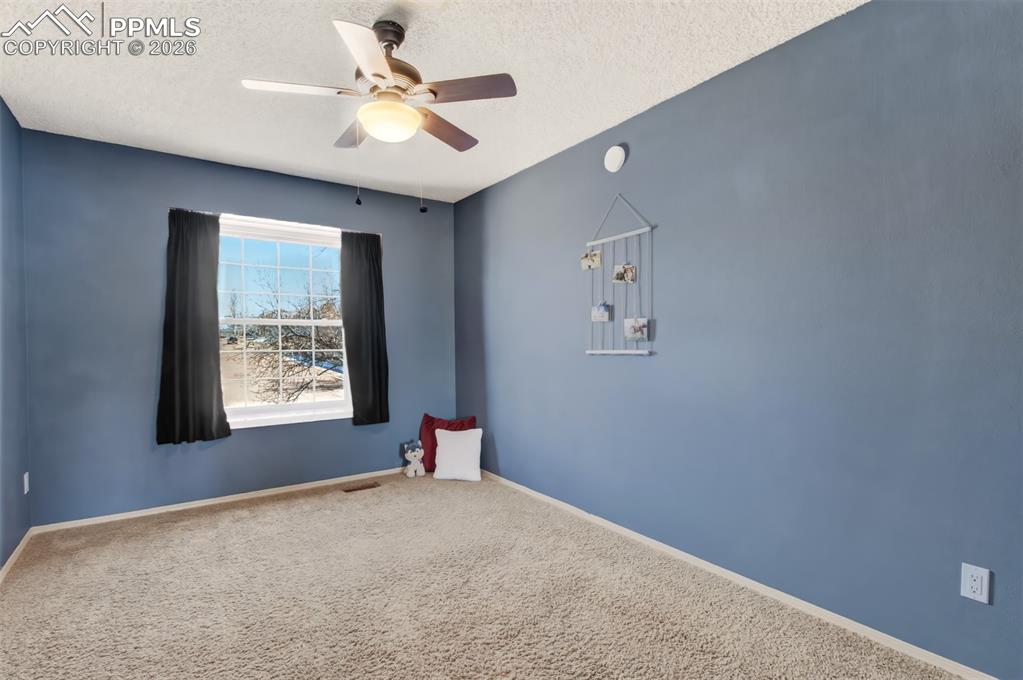 Bedroom #3 with vaulted ceilings and a window seat. 