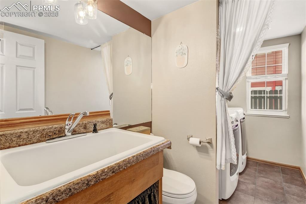 Lower level half bath featuring an oversized sink. 