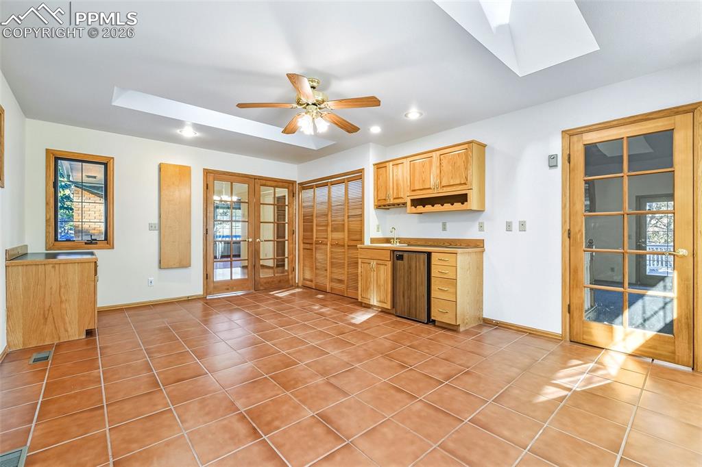 Huge extra Flex room with walk out to backyard deck and built in cabinets and sink.