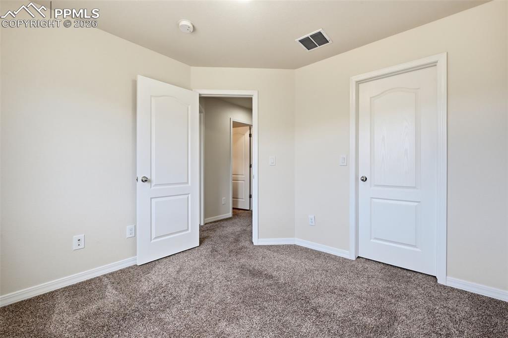 Comfortable bedroom #2 with walk-in closet and flexible use potential.