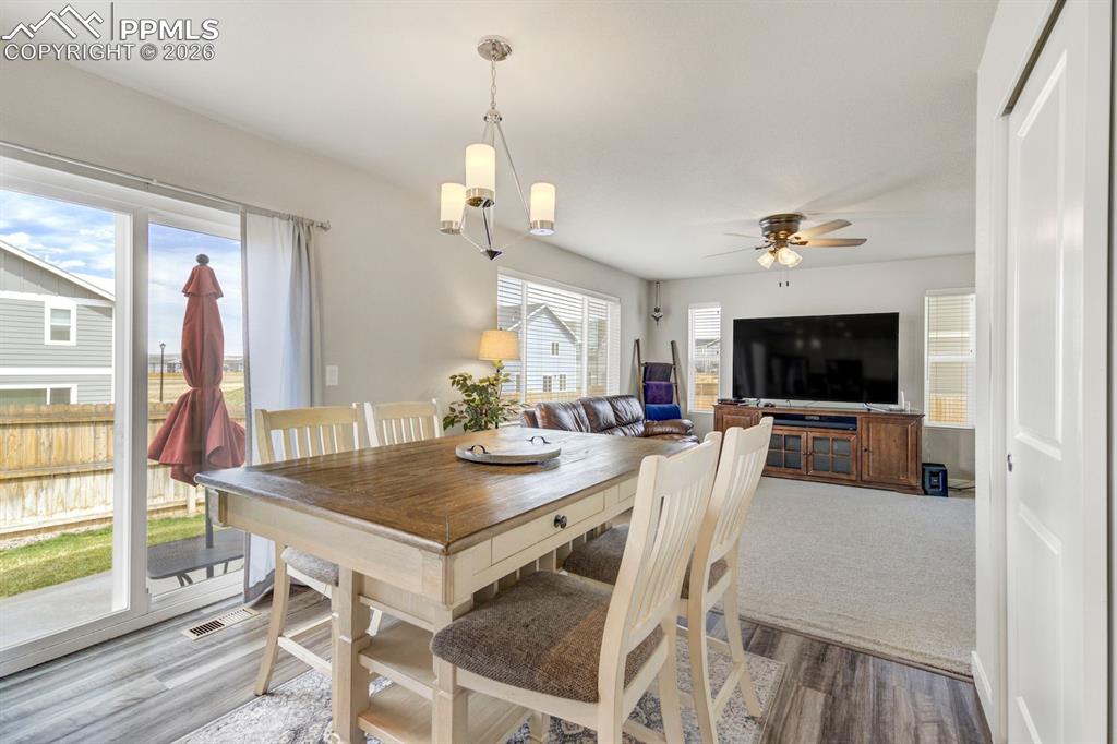 Dining space featuring wood finished floors and ceiling fan