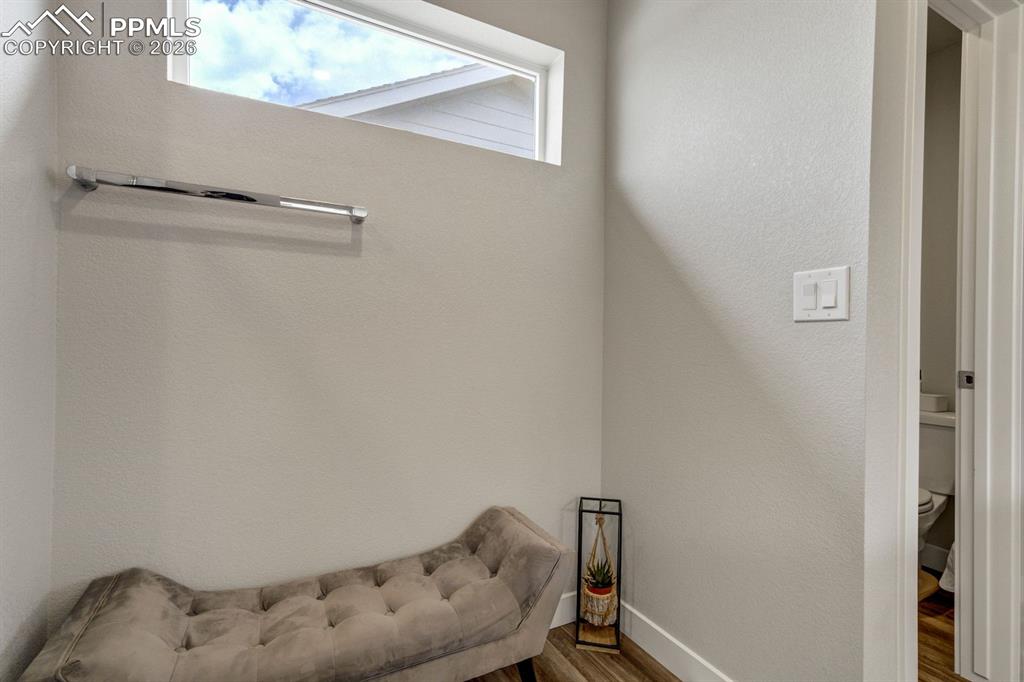 Living area with wood finished floors and baseboards