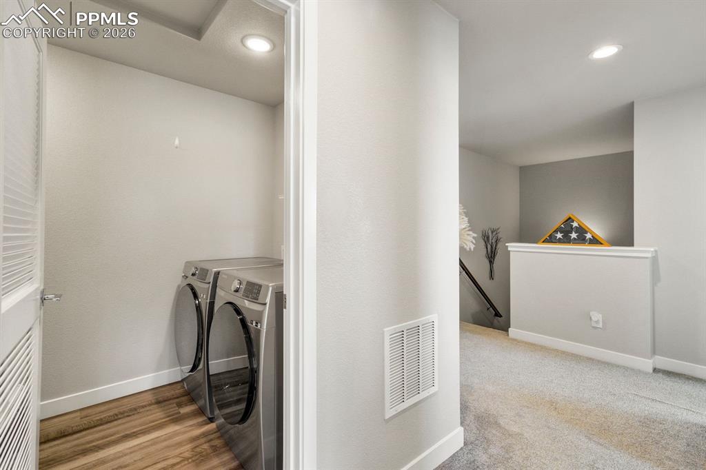 Laundry area with washing machine and dryer and recessed lighting