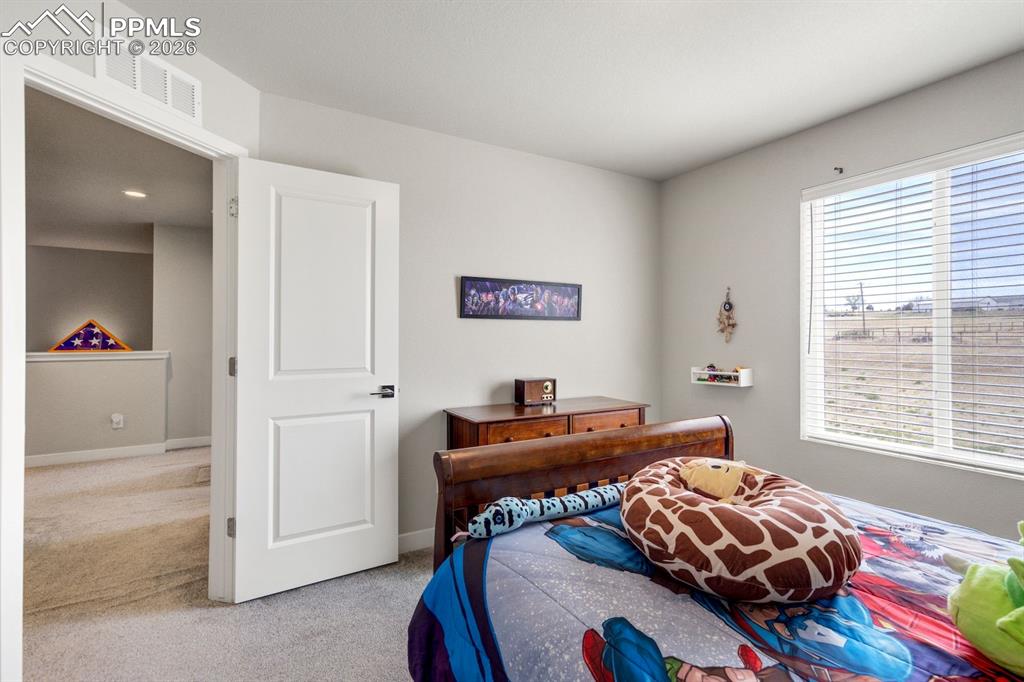 Bedroom featuring carpet flooring and baseboards