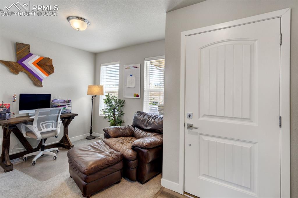 Home office with a textured ceiling and baseboards