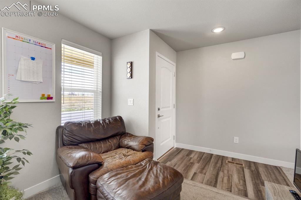 Sitting room featuring baseboards and light wood-type flooring