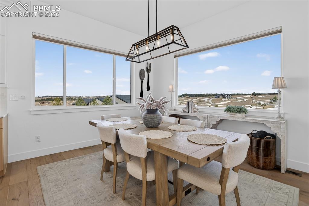 Eat-in kitchen area with designer lighting, automated window shades