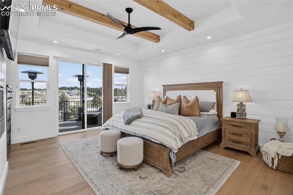 Main floor Primary BR with shiplap walls and knotty alder wood beams