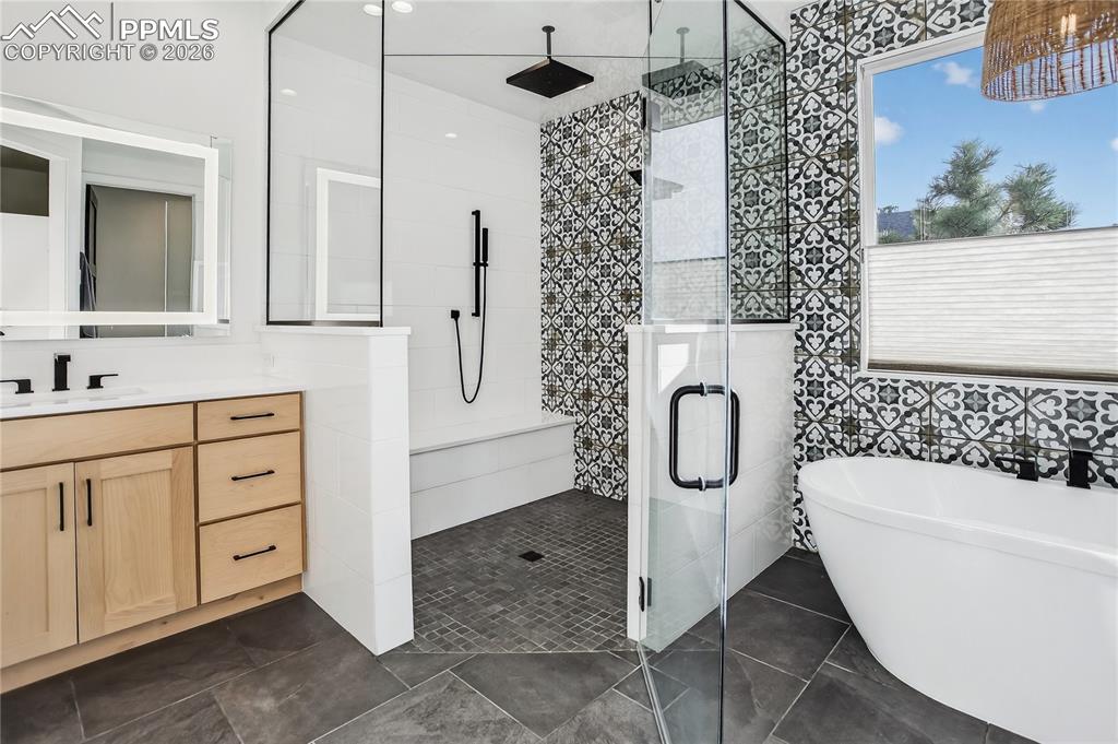 Main floor Primary Bath with walk-in shower, fresetanding tub and radiant heated floors 