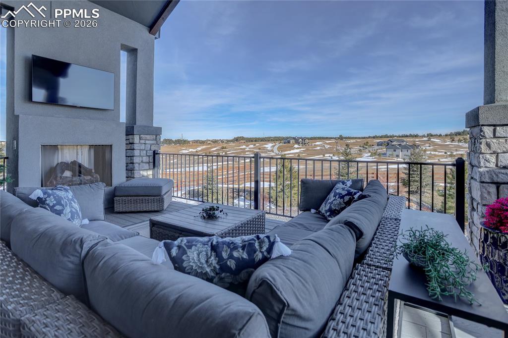Main-level covered composite deck with gas fireplace & TV