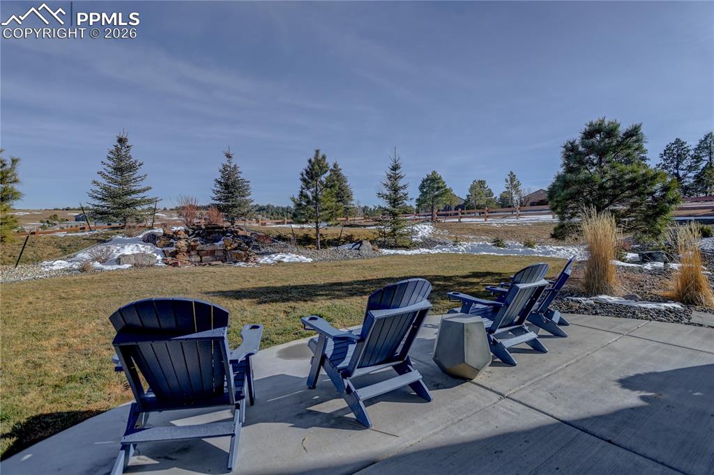 Lower-level open patio area with view of stone water feature