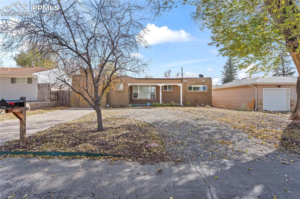 Ranch-style house with stucco siding and concrete driveway