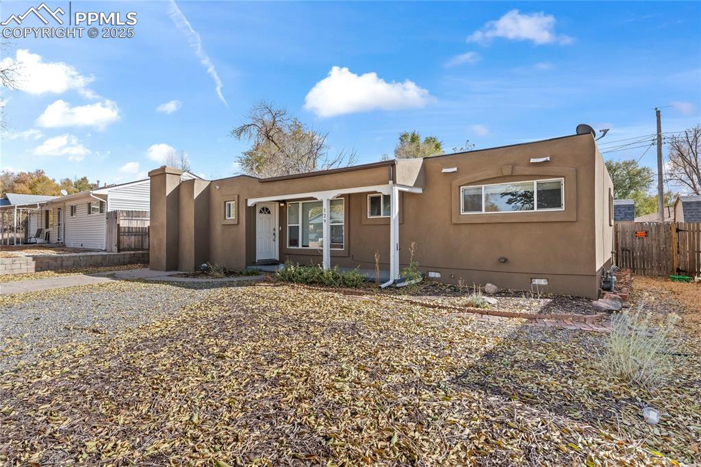 View of front facade featuring crawl space and stucco siding