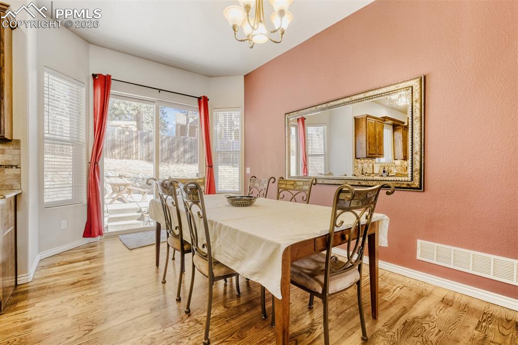 Dining room featuring hardwood flooring and walks out to rear patio