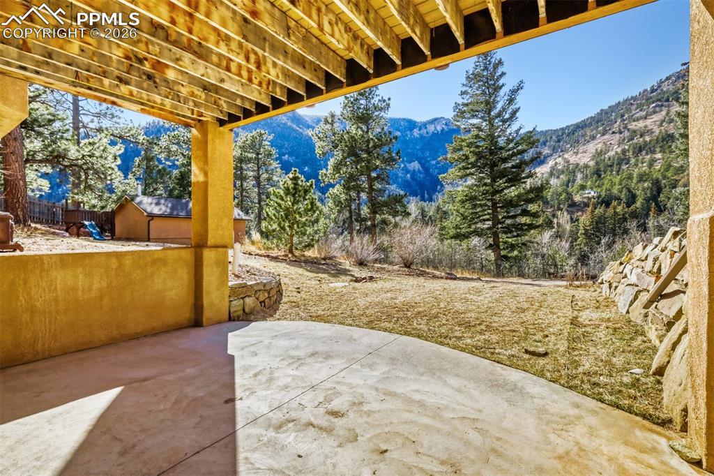 Basement walk out patio / terrace featuring a mountain view