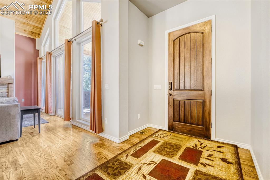 Foyer with hardwood floors and wooden vaulted ceiling