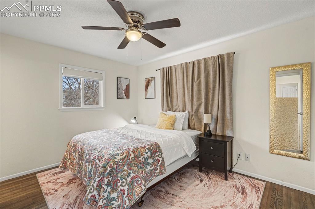 Bedroom with wood finished floors, and ceiling fan