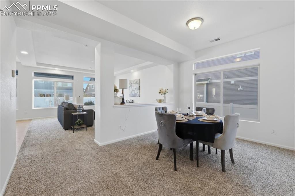 Dining room with light carpet and baseboards