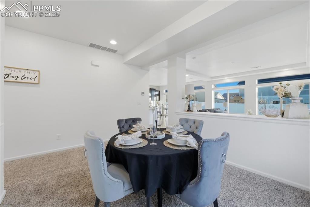 Dining space featuring carpet and recessed lighting