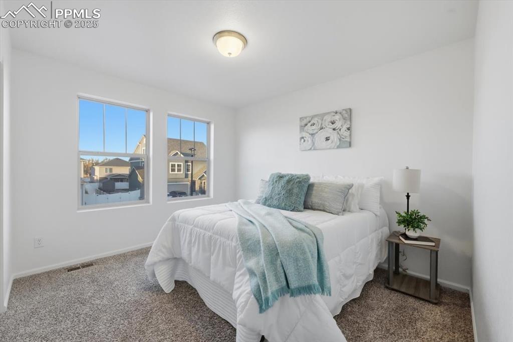 Carpeted bedroom with baseboards