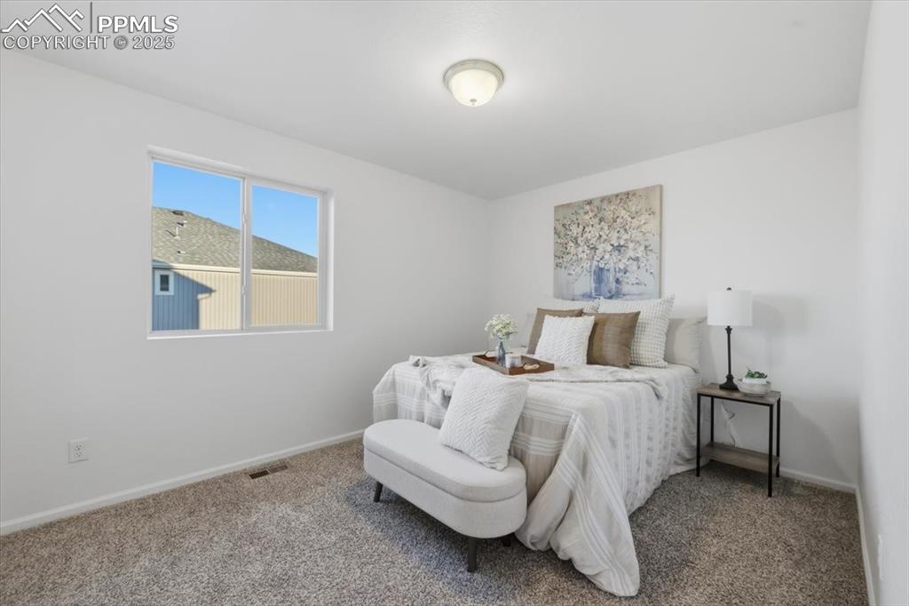 Carpeted bedroom with baseboards