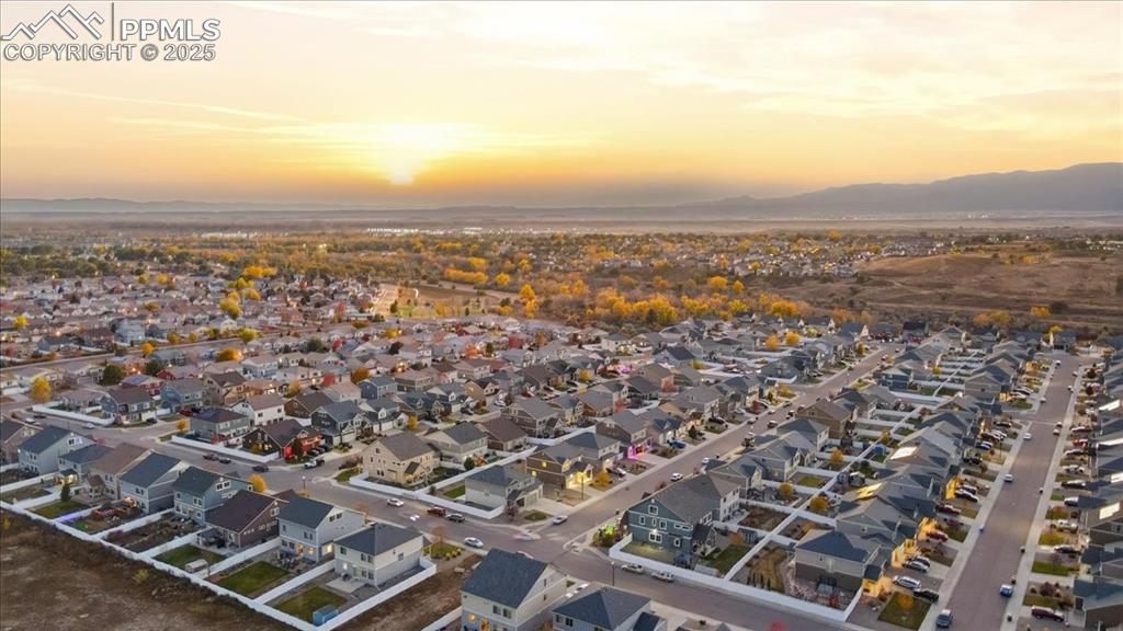 Aerial view of property's location featuring nearby suburban area and a mountain backdrop
