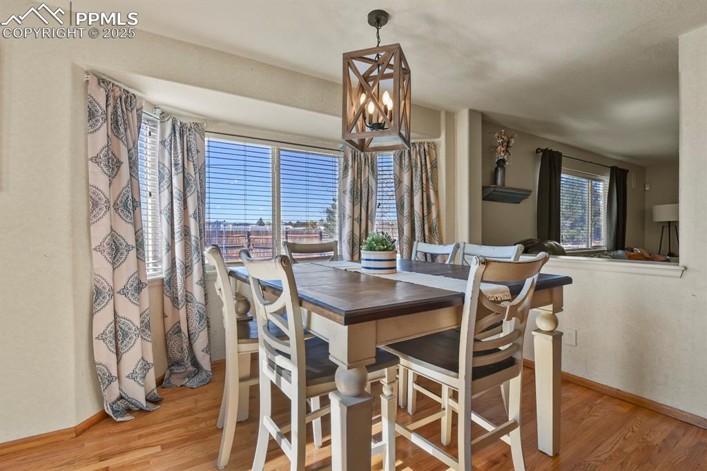 Dining room featuring light wood finished floors and a chandelier