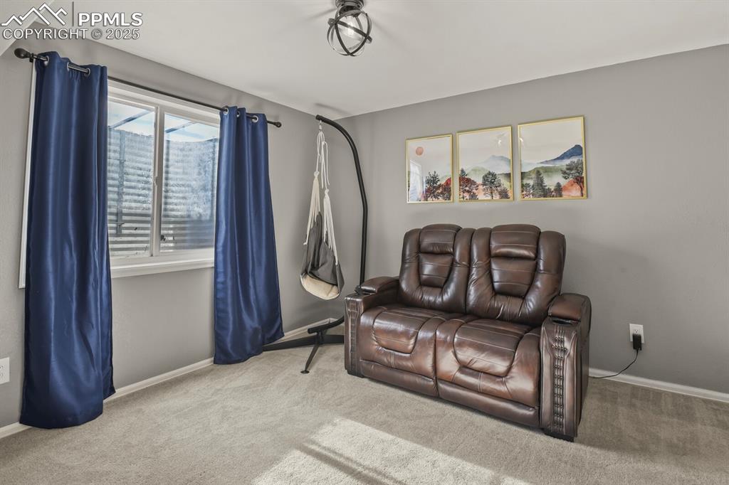Living area with carpet floors and baseboards
