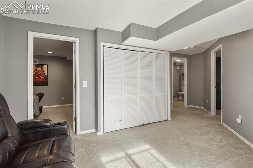 Bedroom with light carpet, a closet, and ensuite bathroom