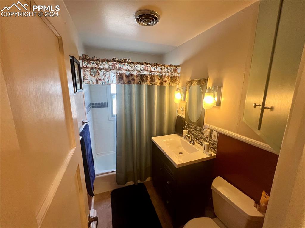 Bathroom with large vanity and toilet