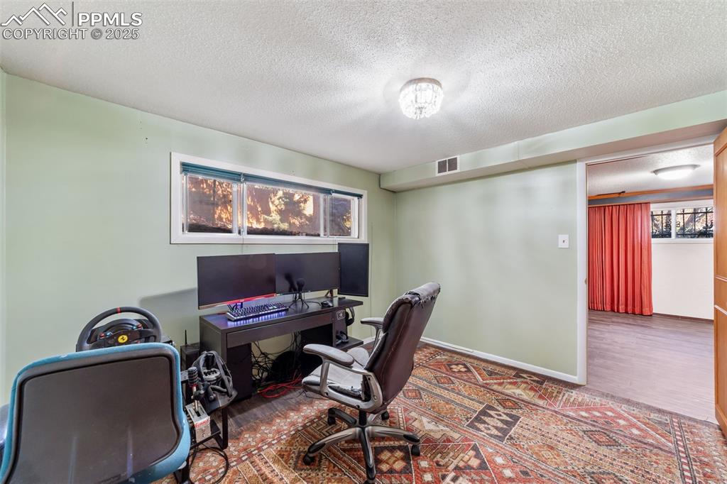 Office space featuring a textured ceiling