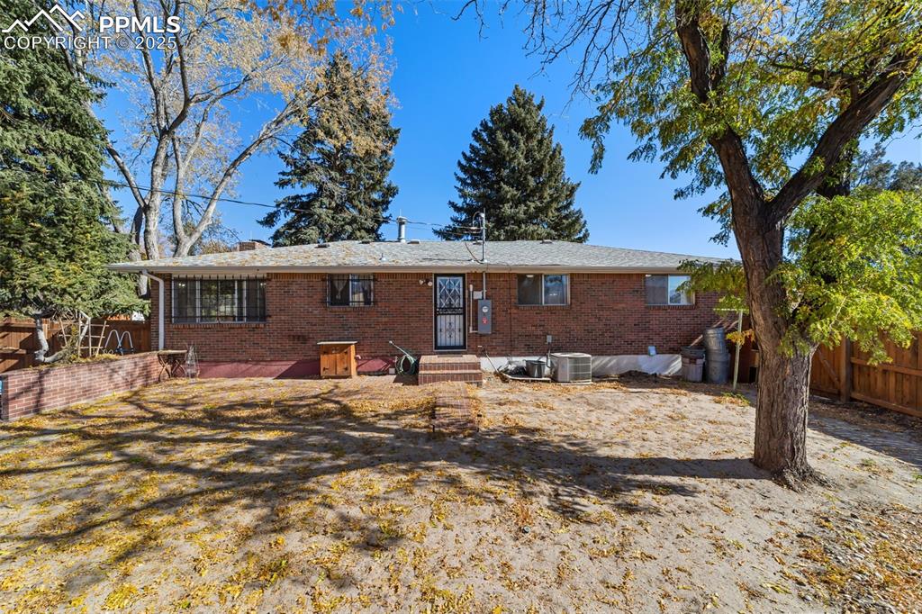 Rear view of house with brick siding and entry steps