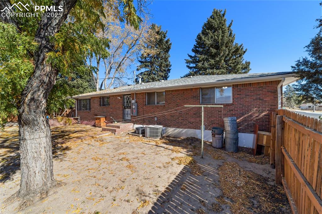 Back of house featuring brick siding