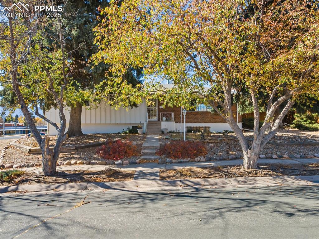 View of front of property featuring covered porch and brick siding