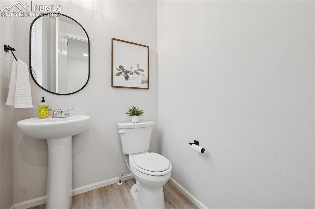 Bathroom featuring wood finished floors and baseboards