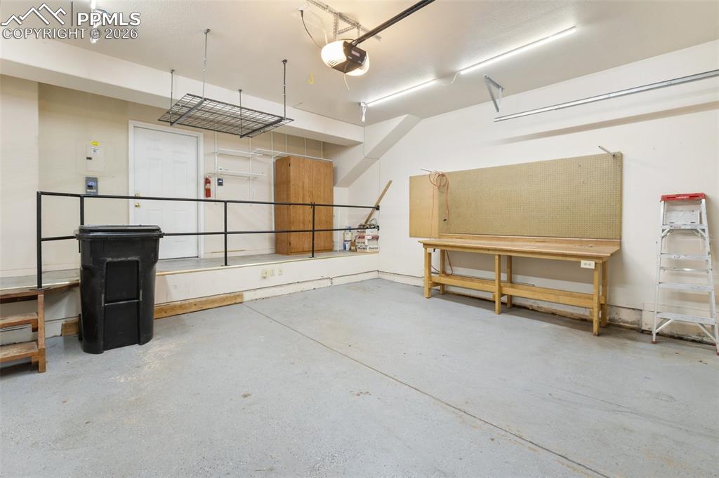 Garage featuring a garage door opener