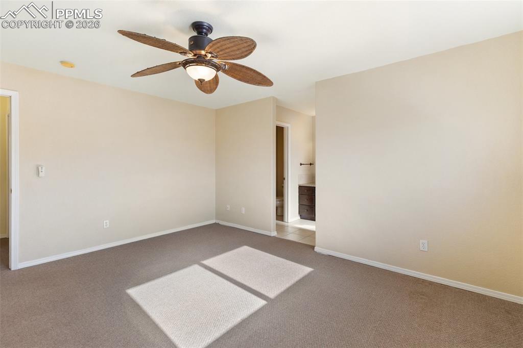 Unfurnished room featuring ceiling fan and light colored carpet
