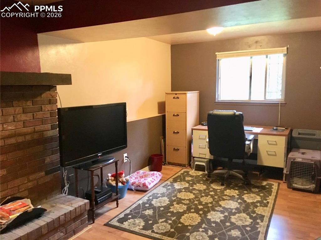 Family room on lower level utilizes an area of the room as an office.