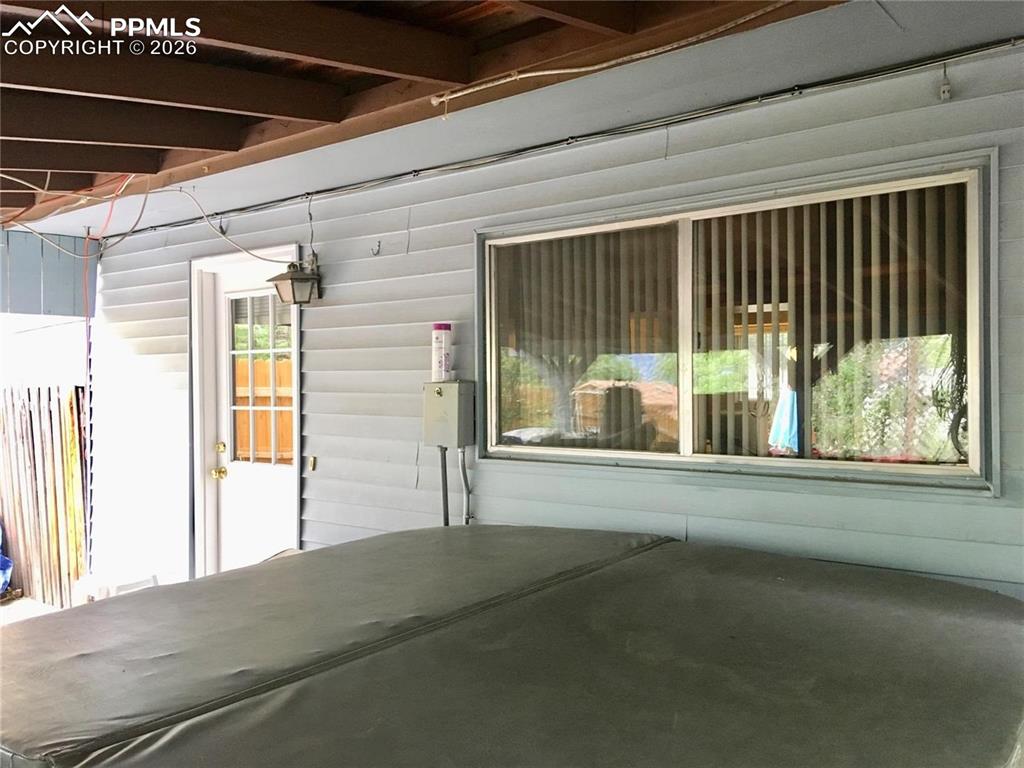 Covered back patio with hot tub that stays. 