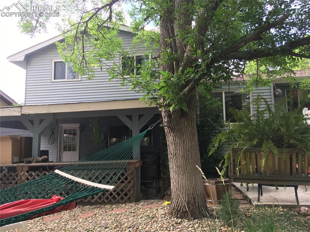 Rear view of home. Hot tub is located on covered patio.