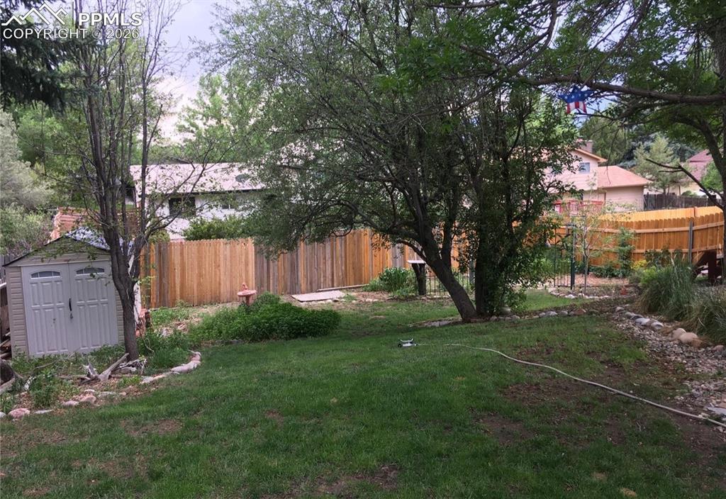 Awesome backyard with mature trees offers space to enjoy outdoor activities.