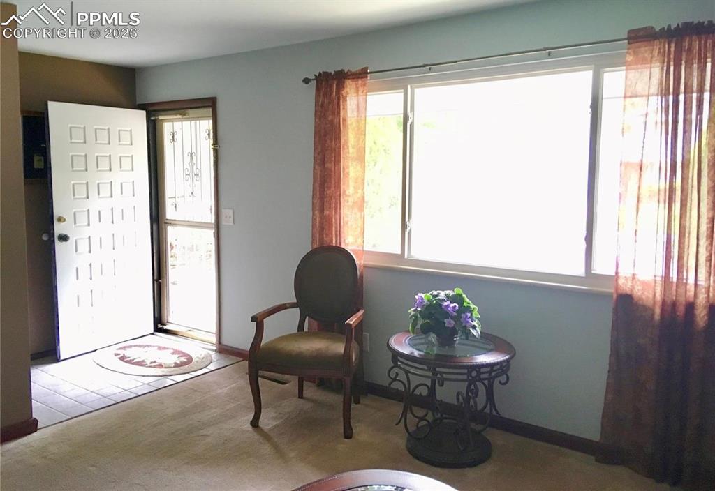Front entry to home flows into formal living room.