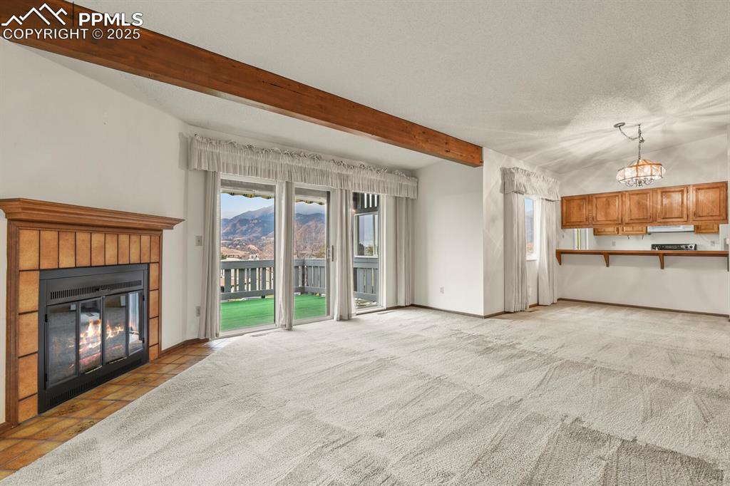 Large Living Room with Wood Fireplace and Open to Covered Patio